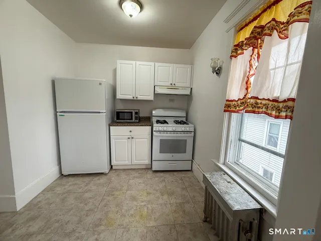 a kitchen with stainless steel appliances a refrigerator sink and cabinets