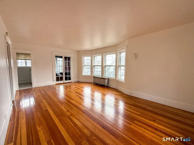 wooden floor in an empty room with a window
