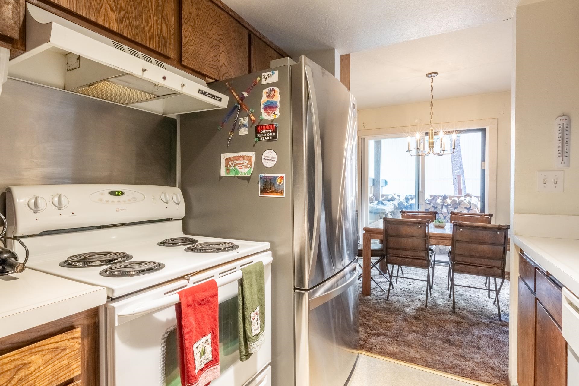 25 Lee Road, Unit 161 Mammoth Lakes, CA 93546 - Photo 17 of 43 a kitchen with a stove a refrigerator and a dining table