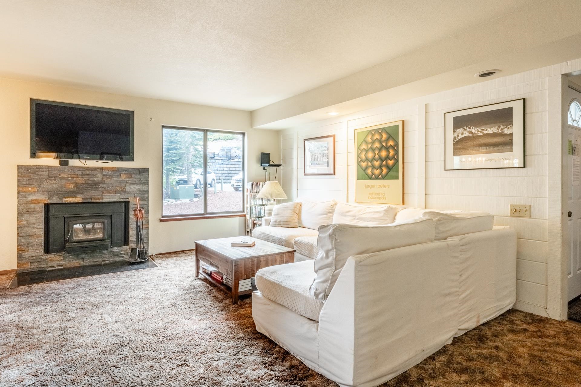 25 Lee Road, Unit 161 Mammoth Lakes, CA 93546 - Photo 7 of 43 a living room with furniture a flat screen tv and a fireplace