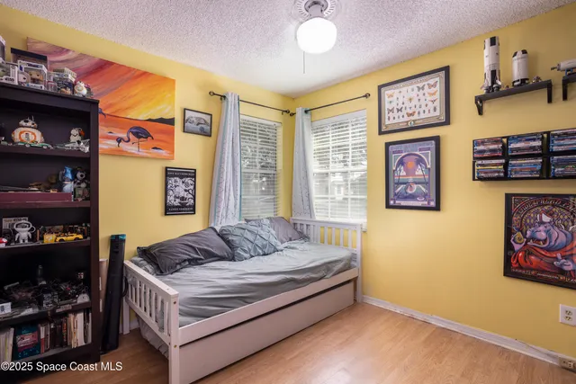 a living room with furniture and a book shelf