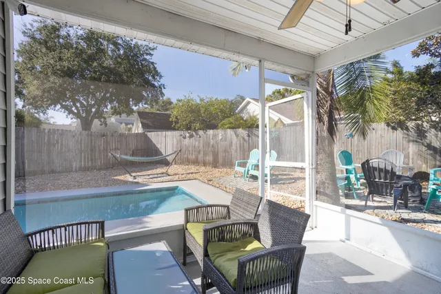a view of a patio with couches table and chairs and potted plants
