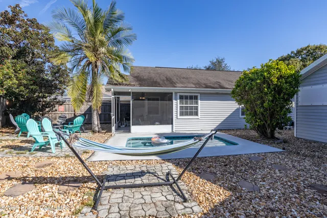 a view of house with backyard space and garden