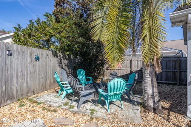a view of a chair and table in backyard