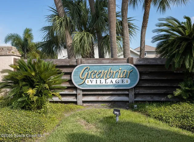 a sign that is on a wooden bench in a yard