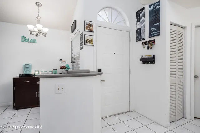 a view of a hallway with chandelier