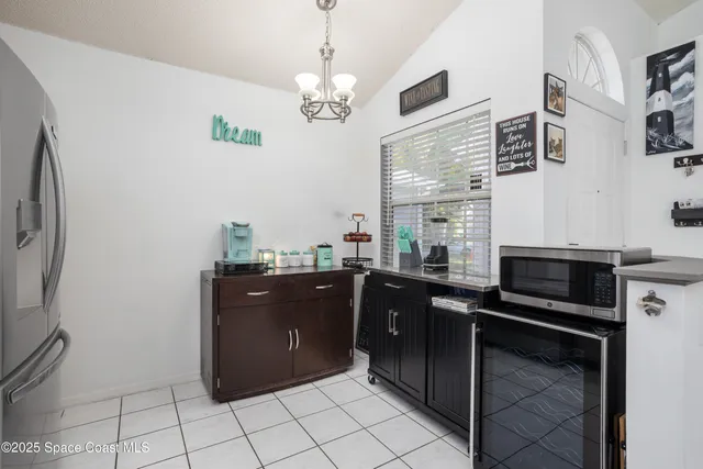 a kitchen with a refrigerator and a stove