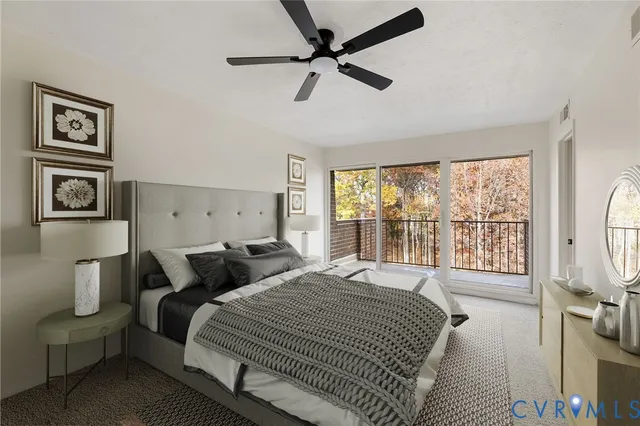 a bedroom with a bed a couch and a large window