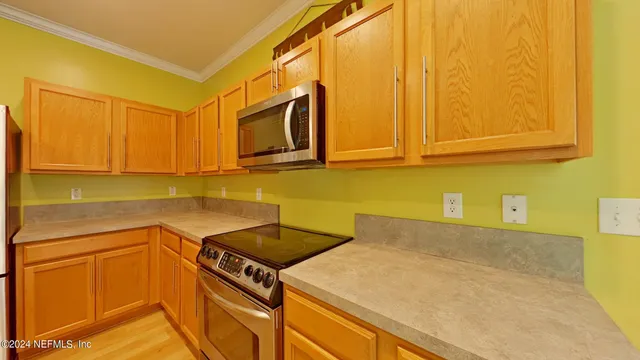 a kitchen with a sink cabinets and a wooden floor