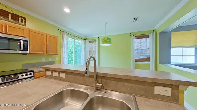 a kitchen with a sink and a large window