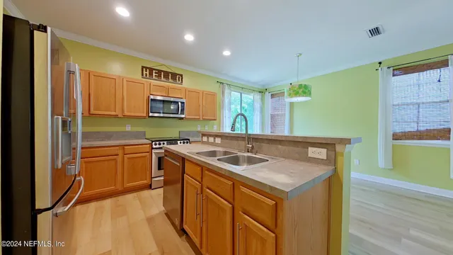 a kitchen that has a sink and a stove in it