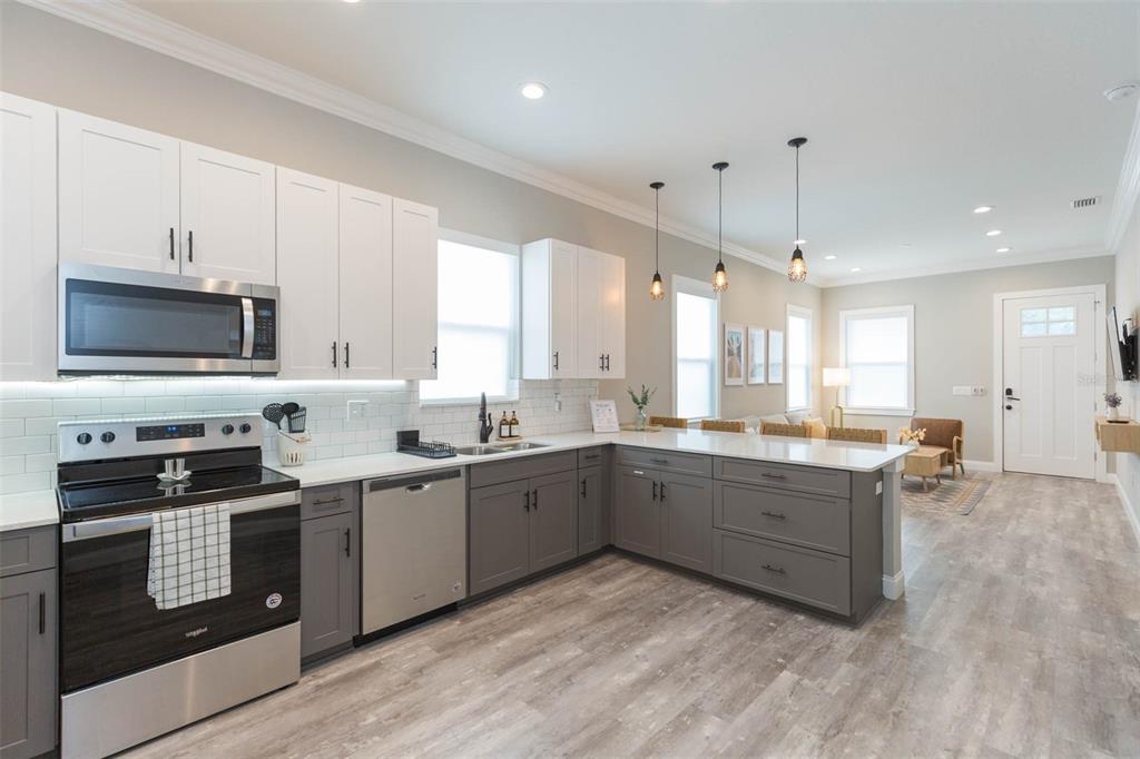 2901 N Boulevard Tampa, FL 33602 - Photo 16 of 63 a large kitchen with cabinets wooden floor and stainless steel appliances