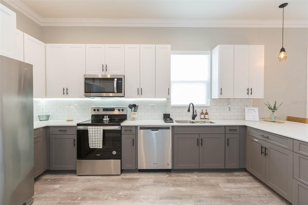 2901 N Boulevard Tampa, FL 33602 - Photo 19 of 63 a kitchen with stainless steel appliances a sink stove and refrigerator