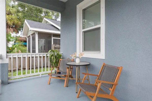a view of a chair and table in the porch