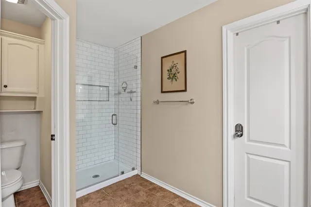 a bathroom with a shower and toilet