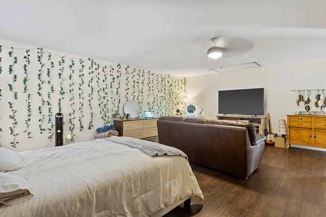 a bedroom with a bed and a television