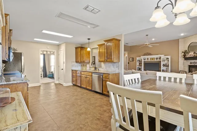 a living room with kitchen island furniture and a flat screen tv