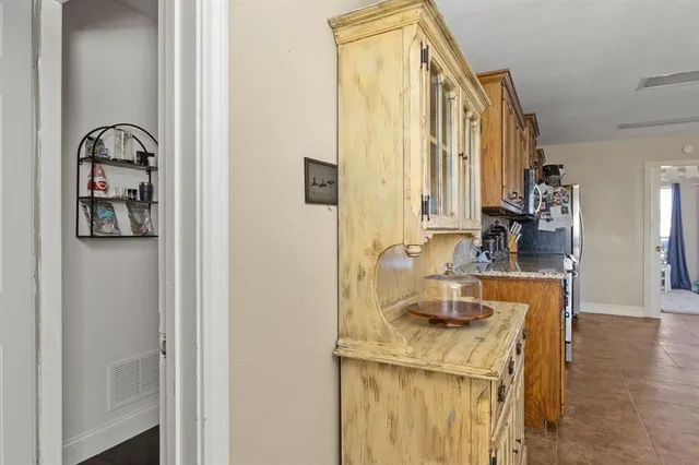 a bathroom with a granite countertop sink a mirror and shower