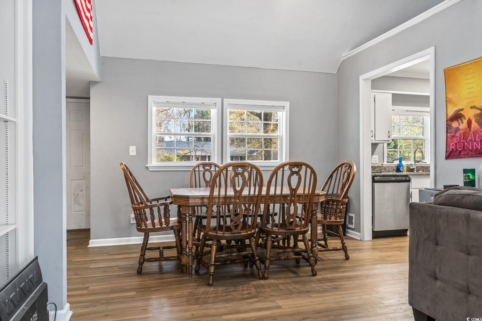 109 Clemson Road Conway, SC 29526 - Photo 16 of 25 Dining space with crown molding and light hardwood