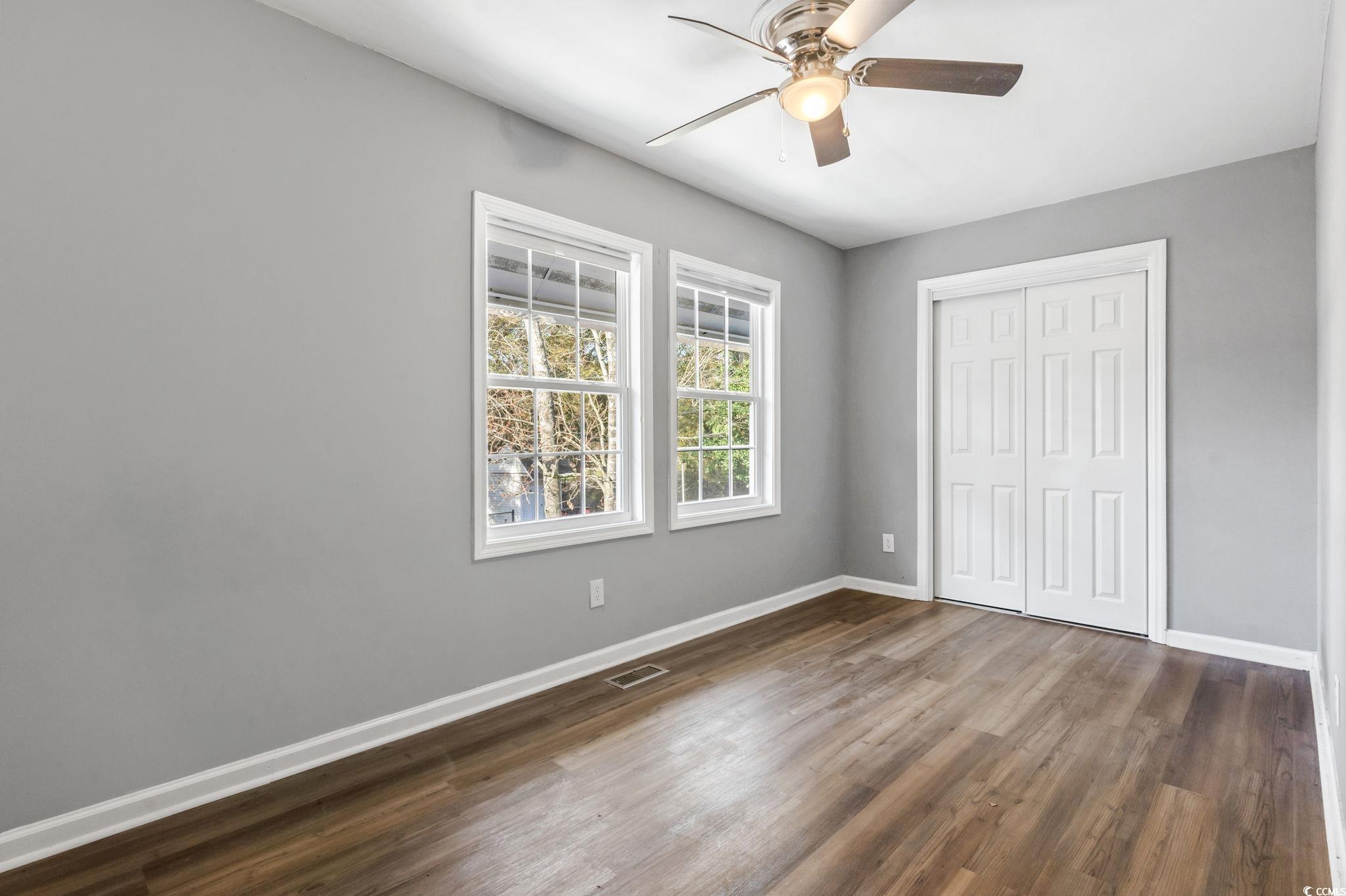 109 Clemson Road Conway, SC 29526 - Photo 9 of 25 Unfurnished bedroom with dark wood-type flooring,