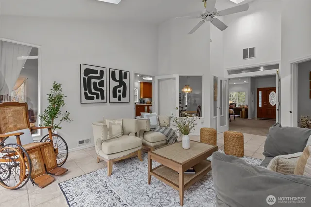 a living room with furniture a rug and a chandelier