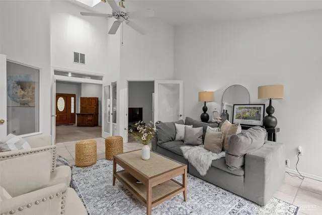 a living room with furniture and a chandelier
