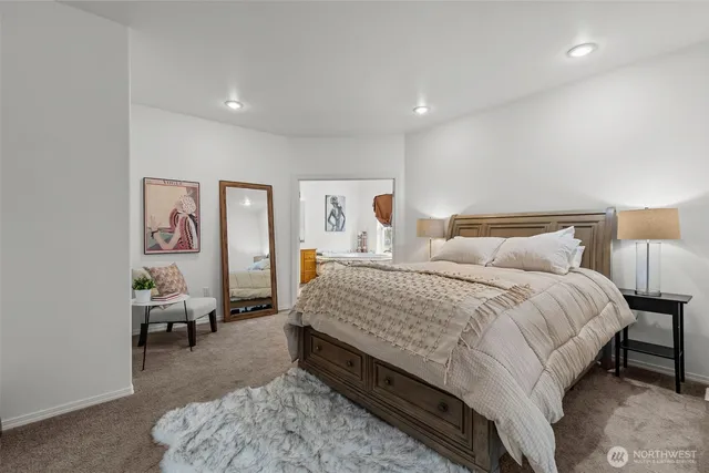 a spacious bedroom with a bed and a couch