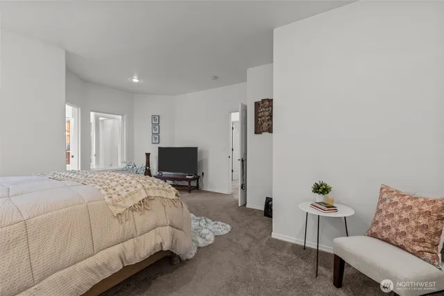 a bedroom with a bed and a couch