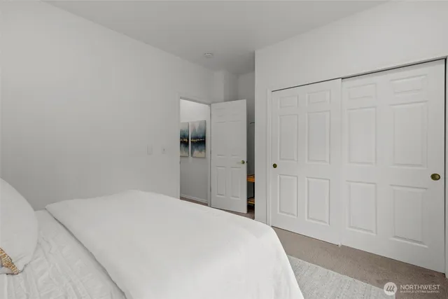 a bedroom with a bed and a cabinet