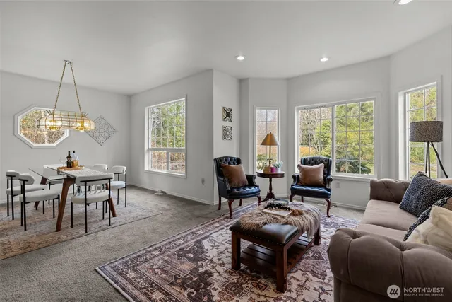 a living room with furniture ceiling window and a table