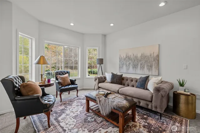 a living room with furniture and a large window