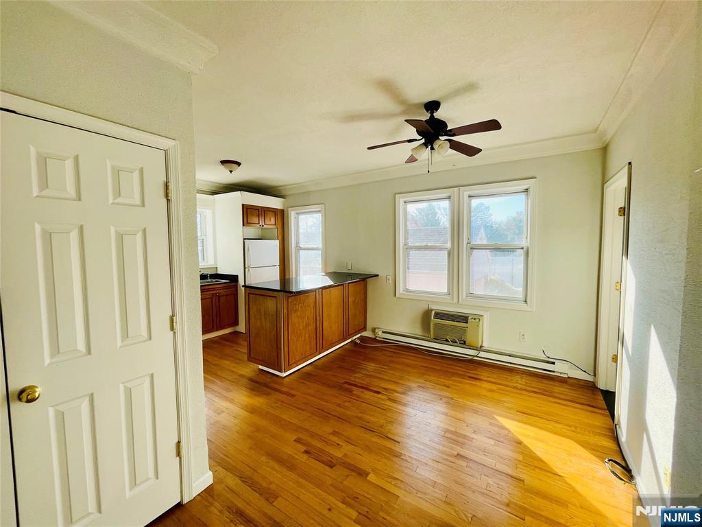 229 Orient Way, Unit 6 Rutherford, NJ 07070 - Photo 5 of 8 wooden floor and windows in an empty room