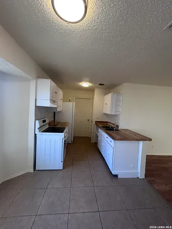 a kitchen with stainless steel appliances a refrigerator and a stove