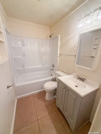a bathroom with a sink a toilet and a shower