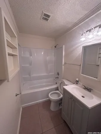a bathroom with a sink mirror toilet and bathtub