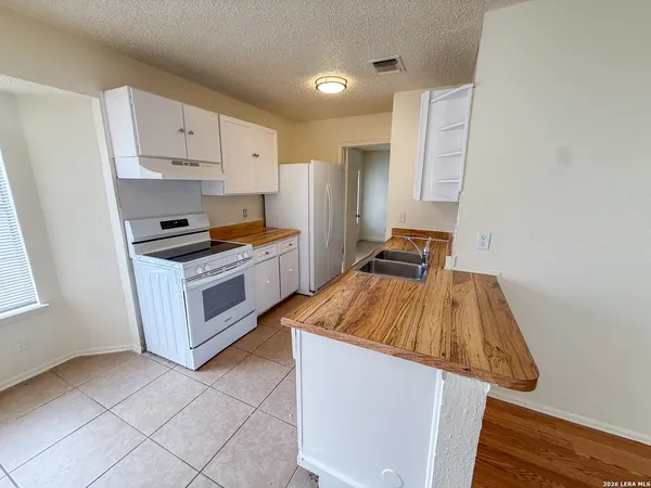 a kitchen with a sink and a refrigerator