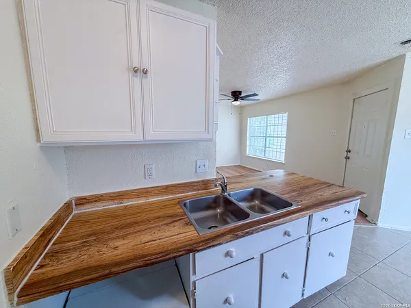 a kitchen with cabinets and window