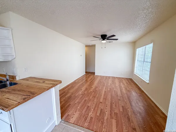 a view of a kitchen with a sink and wooden floor