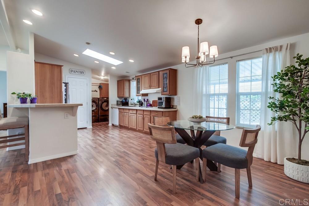 120 Brookside Lane Oceanside, CA 92056 - Photo 13 of 55 a view of a dining room with furniture window and wooden floor