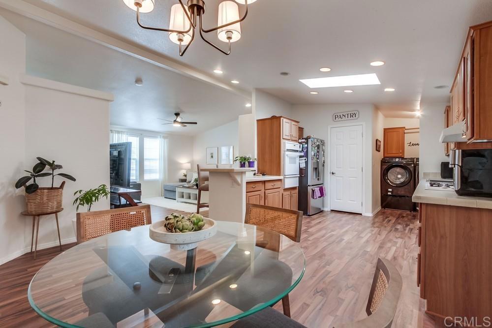 120 Brookside Lane Oceanside, CA 92056 - Photo 14 of 55 a living room with stainless steel appliances furniture a rug kitchen view and a chandelier