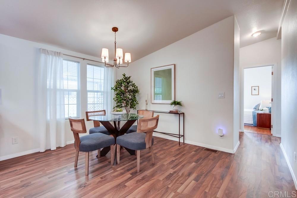 120 Brookside Lane Oceanside, CA 92056 - Photo 15 of 55 a view of a dining room with furniture window and wooden floor