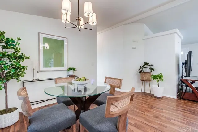 a kitchen with stainless steel appliances granite countertop a refrigerator a sink dishwasher and a stove with wooden floor