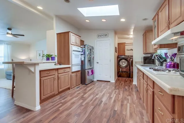 a kitchen with stainless steel appliances granite countertop a refrigerator and cabinets