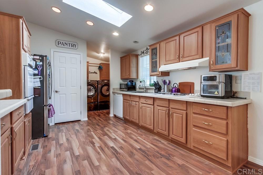 120 Brookside Lane Oceanside, CA 92056 - Photo 19 of 55 a kitchen with stainless steel appliances granite countertop a refrigerator and cabinets
