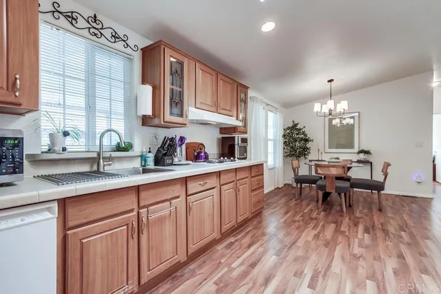a kitchen with stainless steel appliances granite countertop a sink a cabinets and a window