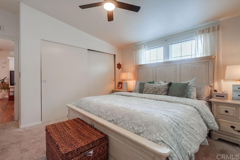 120 Brookside Lane Oceanside, CA 92056 - Photo 24 of 55 a bedroom with a bed and a chandelier