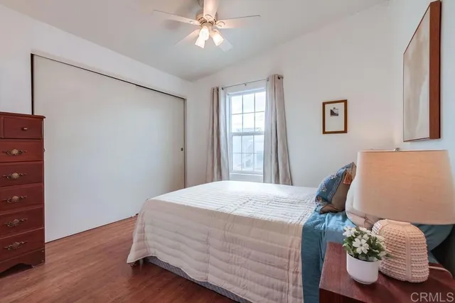 a living room with furniture a ceiling fan and a window
