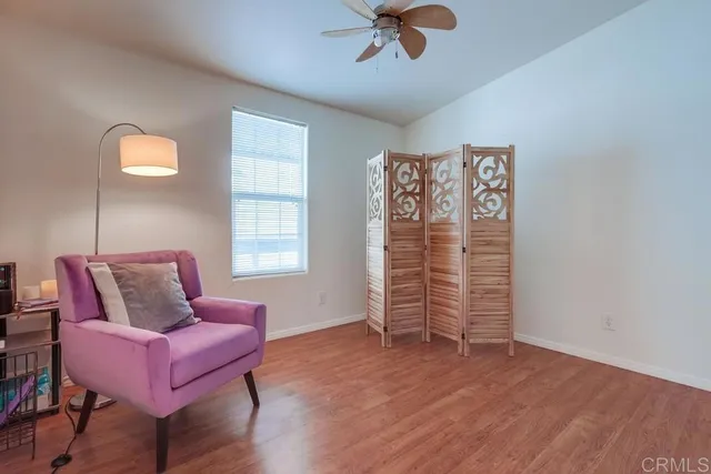 a view of a room with wooden floor and a bathroom