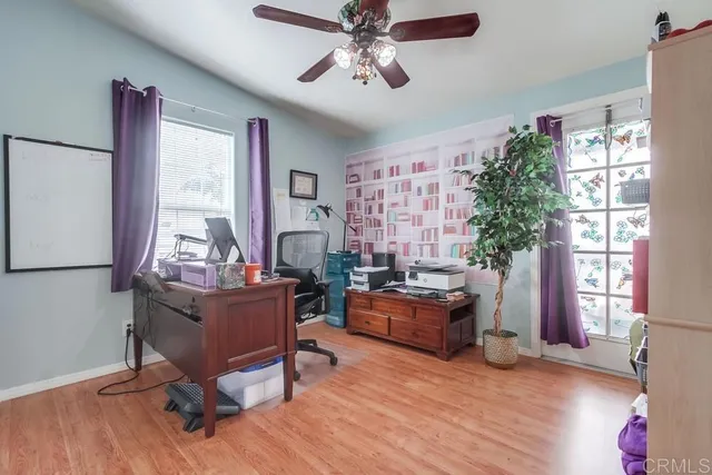 a view of a workspace with furniture and a window