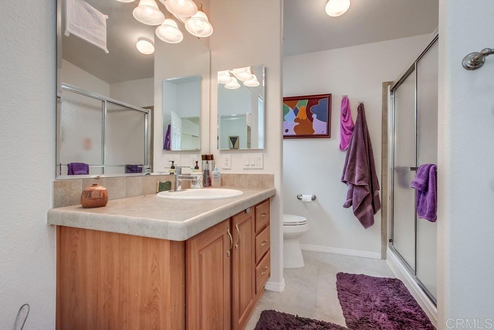 120 Brookside Lane Oceanside, CA 92056 - Photo 40 of 55 a bathroom with a sink vanity and mirror